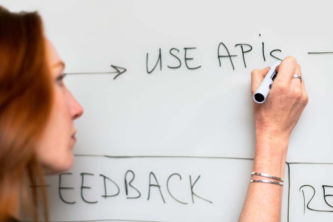 Female software engineer uses whiteboard